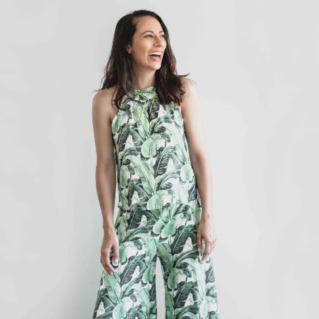 Kyah O'Connor in a green dress holding a singing bowl